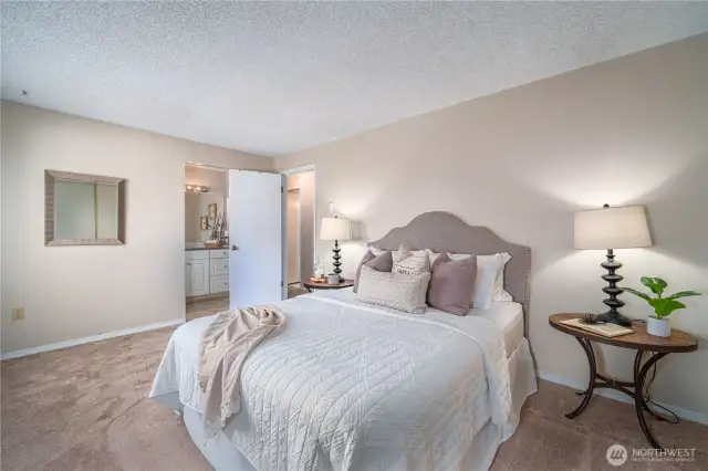 The serene primary bedroom offers comfort and quiet at the end of your day.
