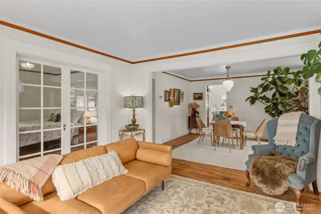 Original hardwood floors and trim flow throughout open living space