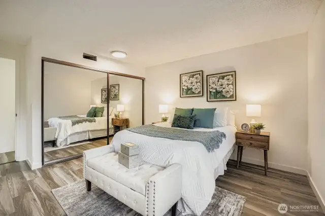 Bright and spacious bedroom featuring oversized windows, fresh paint, and a generously sized closet