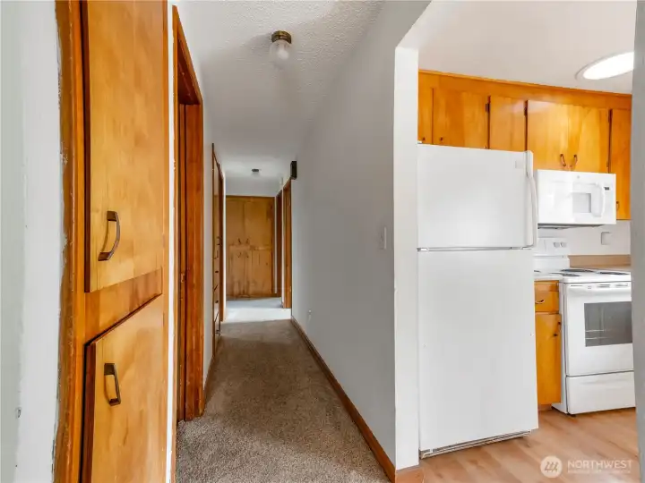 The hallway has built-in cabinets for storage