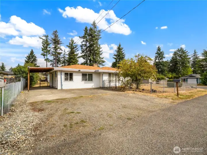 Lots of parking between the driveway, carport, and detached garage