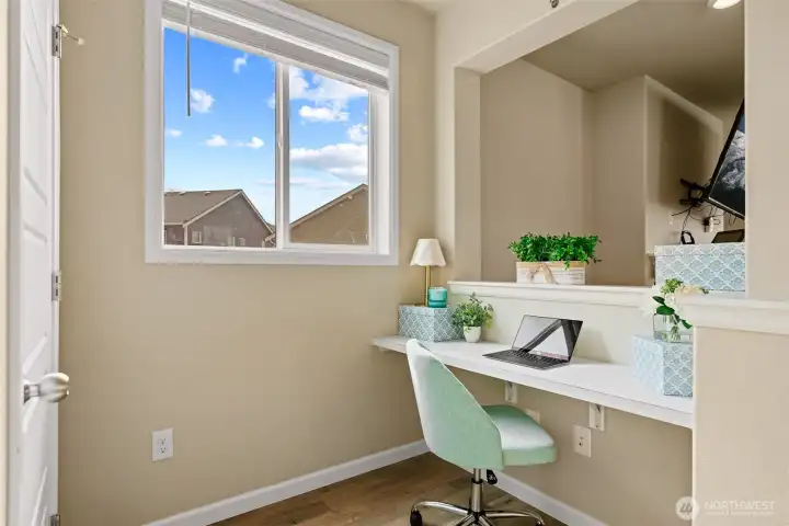 Tech center off of kitchen creates a space for homework or running the household while still being present.