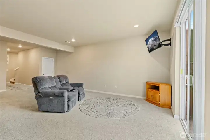 Large lower family room or playroom with outside access