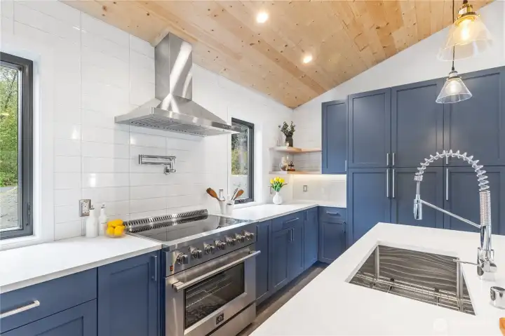stainless steel appliances, pot filler over the stove, and custom cabinetry.