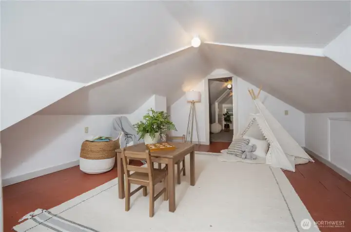 The upstairs offers additional versatile space, perfect for a guest room, home office, or cozy hangout area.