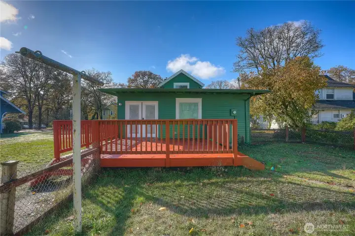 Facing the back deck from the outbuilding.