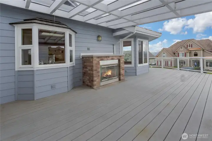 beautiful covered deck area with fireplace wraps to front