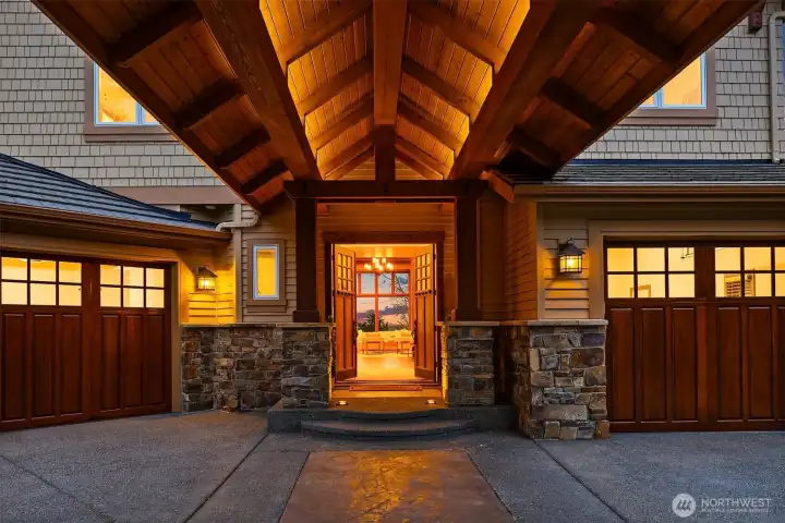 Porte-cochère entrance with recessed soffit lighting.