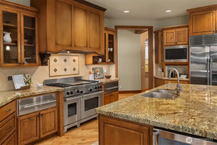 A True Gourmet Kitchen with Designer appliances including Sub Zero refrigeration, Wolf Dual Gas oven & Range with Grill, Dual warming Drawers, Viking Beverage Cooler - Classic Granite Island and Counter Tops, Prep Sink.