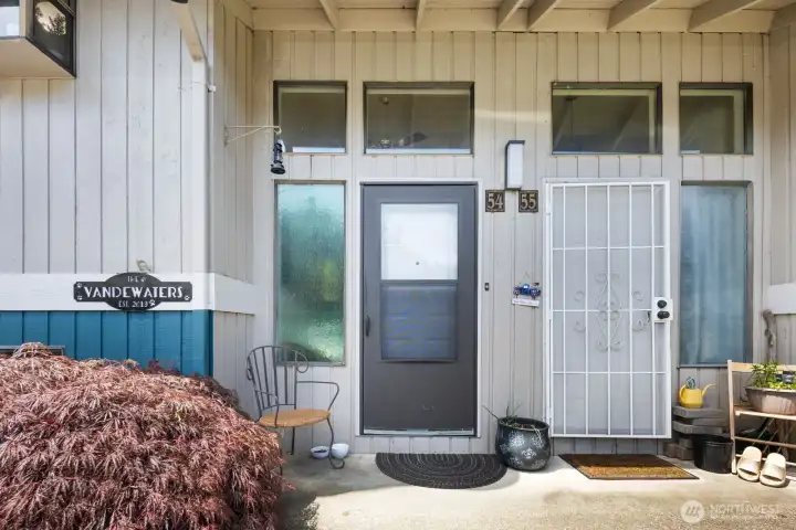 Covered front entrance with oversized windows bringing natural light into the home.