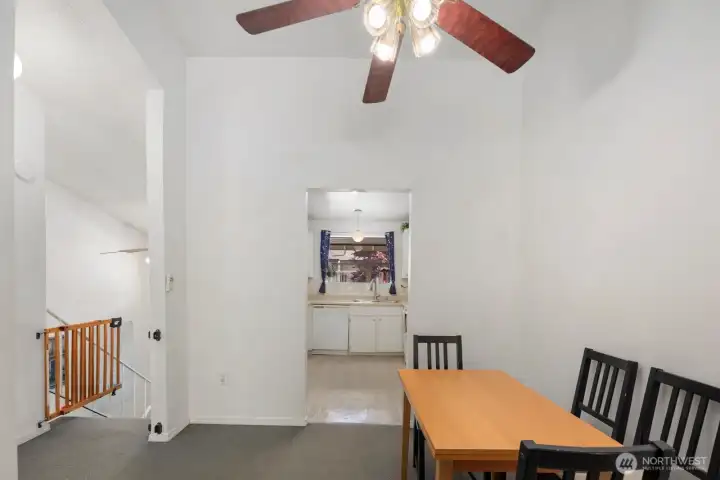 Dining area with elevated ceilings and open connection to the kitchen and main living spaces.