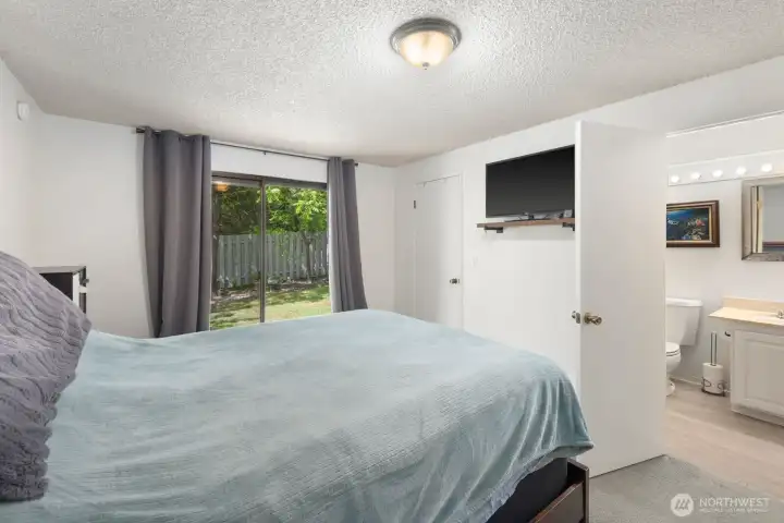 Bedroom with ensuite bathroom access, natural light, and a quiet, private feel.