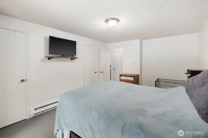 Generous bedroom layout with direct outdoor access and room for additional storage or seating.