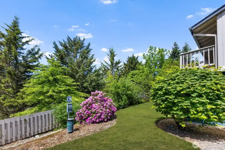 Community green space with mature landscaping and natural privacy throughout.