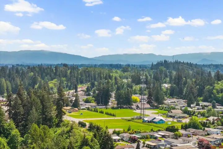 Community nestled against a backdrop of trees and rolling landscape.