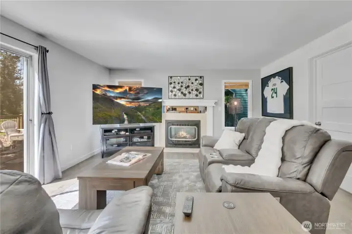Great room has gas fireplace and slider to backyard and golf course