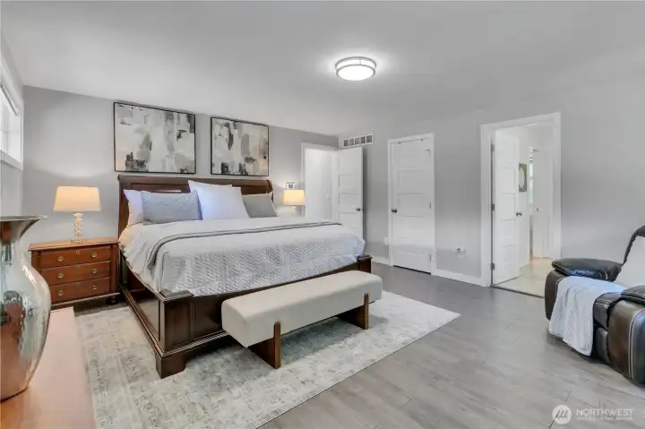 Large primary suite with walk-in closet and new Lux vinyl plank flooring