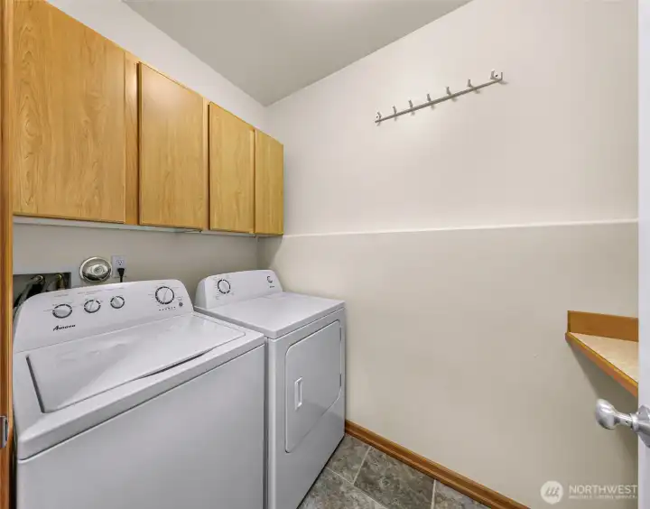 Utility room located on lower level with additional storage and folding table Utility room located on lower level with additional storage and folding table