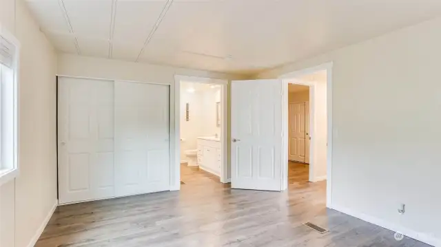 View of double closet and entrance to master bath.