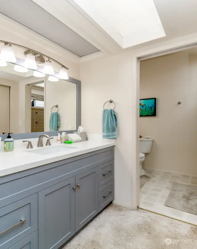 The vanity and second closet are just outside the shower and toilet area, making it easy to share on busy schedules.