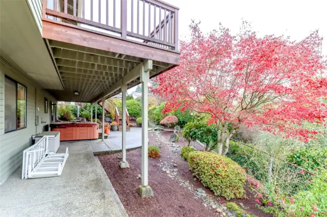 This view of the back patio emphasizes the lovely plantings and entertainment areas.