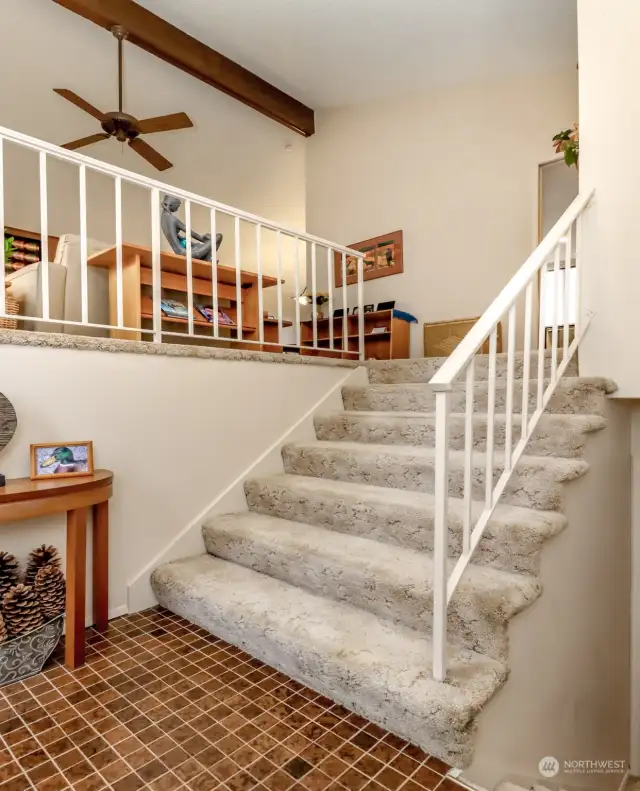 The split level entry has wide staircases and open high vaulted ceilings as you enter.