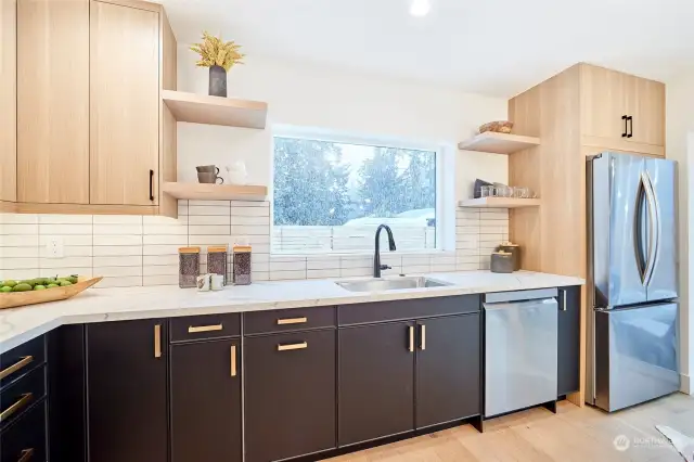 The bright, light-filled kitchen has beautiful two-toned cabinets and open to the living area, making it the perfect place to entertain.