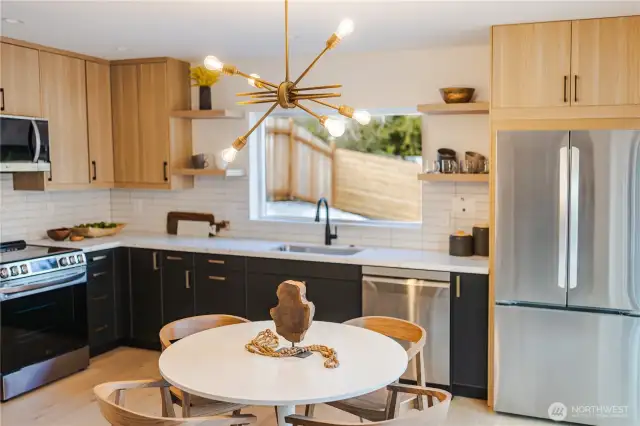 Luxury finishes in the stylish kitchen overlooking sprawling, fenced yard.