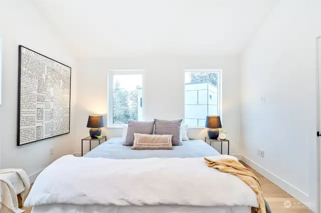 Clean lines with three windows to capture all the natural light in this upper floor bedroom.