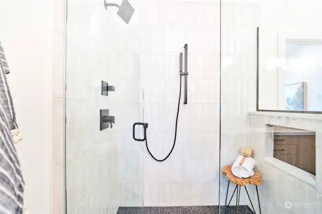 Oversized luxurious shower with classic tile surround.