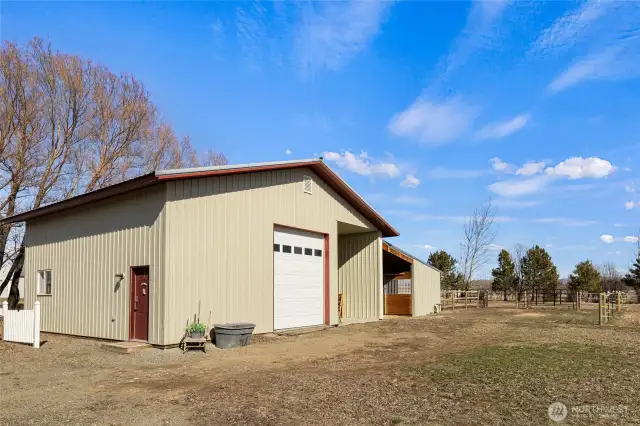 Large shop, finished inside with attached covered RV parking. Electric overhead door opener, heated and wired with 210.