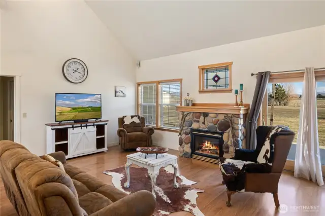 A stone fireplace with natural gas serves as the focal point of the living room.