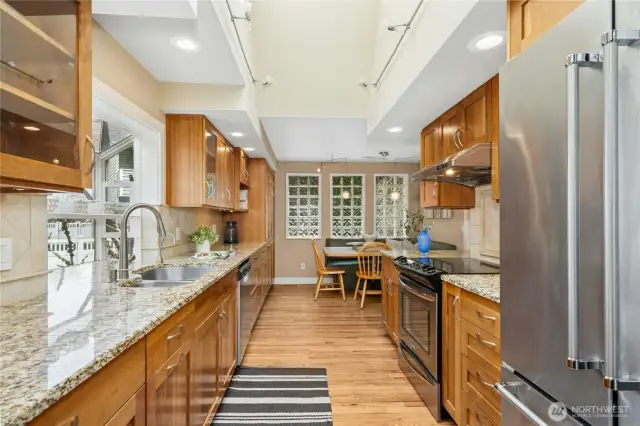 Richly appointed kitchen features extensive counterspace, stainless appliances and a casual banquette.