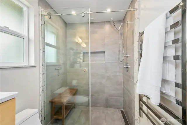 Large walk-in shower and heated towel rack.