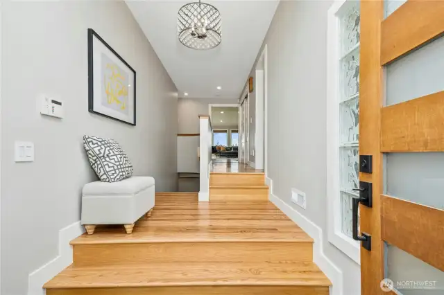 The entry offers a light-filled glimpse of what is to come.