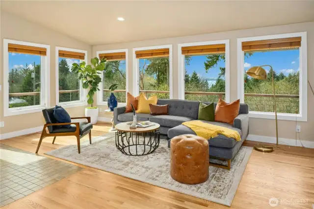 The stunning living and dining area features cathedral ceilings, abundant windows and both wood and tile flooring creating a sense of oneness with the outdoors.