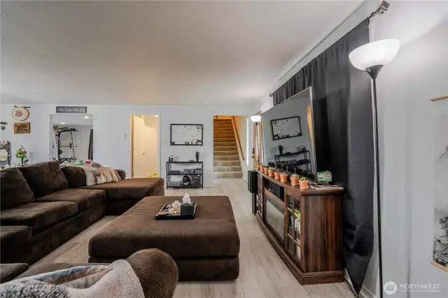 View from living room to stairs, full bathroom on the main, and entry to the recreation room