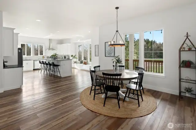 Dining table leading into the expansive custom kitchen