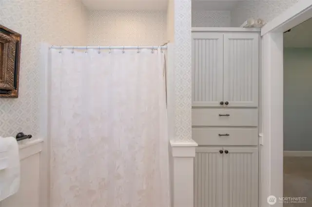ADU primary bathroom with shower and built-in storage