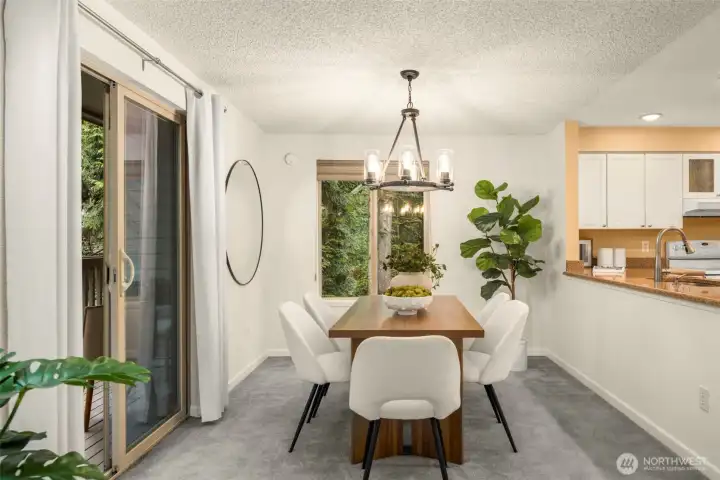 Enjoy meals with a view — dining space with deck access and seamless flow to the kitchen.
