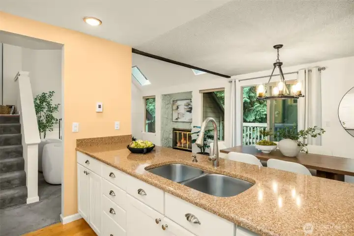 Cook and entertain with ease — the kitchen opens to the dining and living areas, creating an easy flow. Perfect for gatherings, everyday living, or simply enjoying the treetop views.