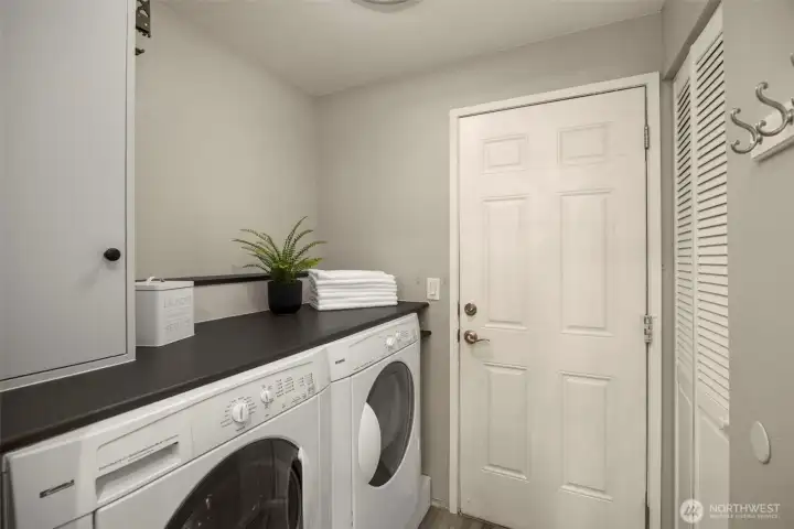 Enjoy an updated laundry room with full-size washer/dryer, a counter that makes folding effortless, and a hidden water tank for a cleaner, more organized space.