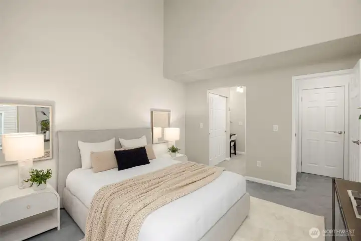 Spacious primary retreat with vaulted ceilings, direct access to 2 large closets, a sitting area, and updated bath.