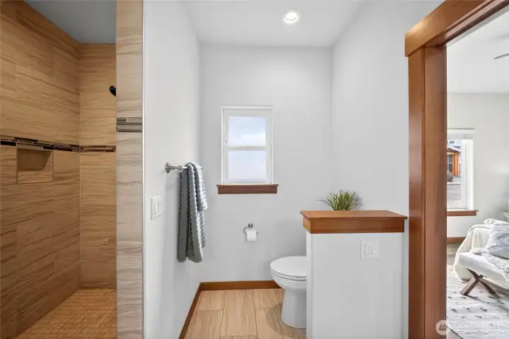 En-suite bathroom with walk-in tile shower.