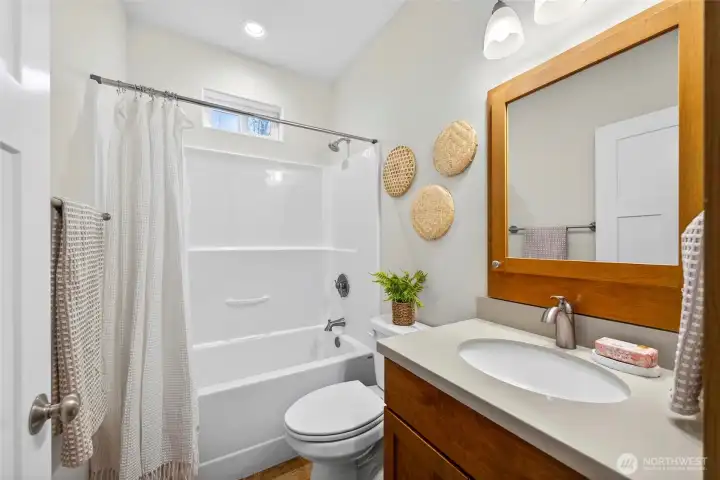 Full bath is situated between the additional two bedrooms.