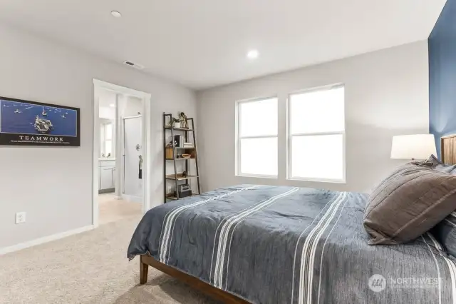 Primary Bedroom with Ensuite Bath & Walk In Closet. Photo of model home and not of same design.  Photos are for representational purposes only. Colors and options may vary.