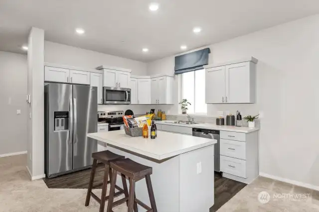 Kitchen with Island & Eating Bar. Photo of model home and not of same design.  Photos are for representational purposes only. Colors and options may vary.