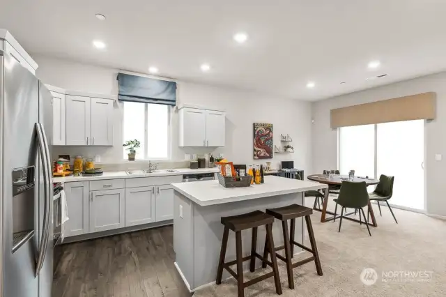Kitchen with Island & Stainless Appliances. Photo of model home and not of same design.  Photos are for representational purposes only. Colors and options may vary.