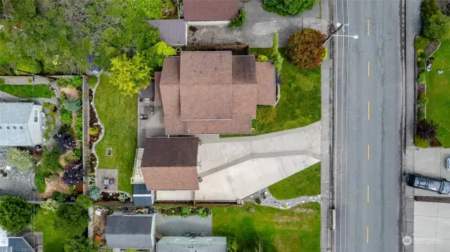 Aerial view of home showcases large driveway with room for RV parking and detached two car garage.