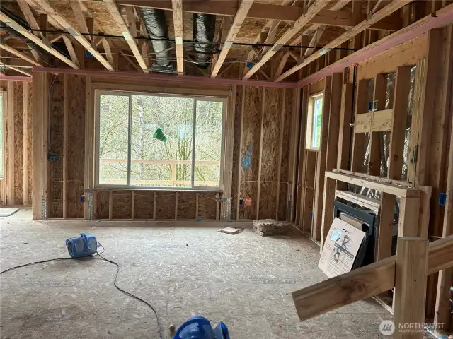 Great room shows treed view beyond.